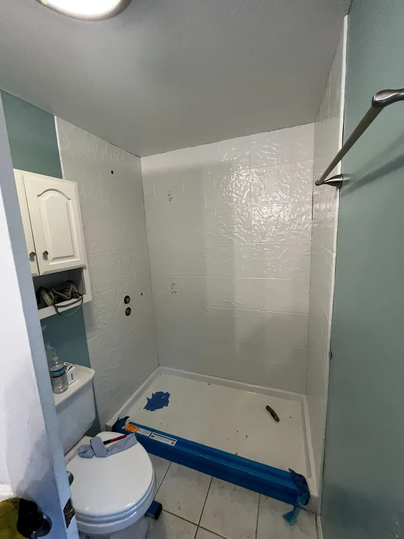 Wide view of the finished acrylic enclosure from the bathroom doorway
