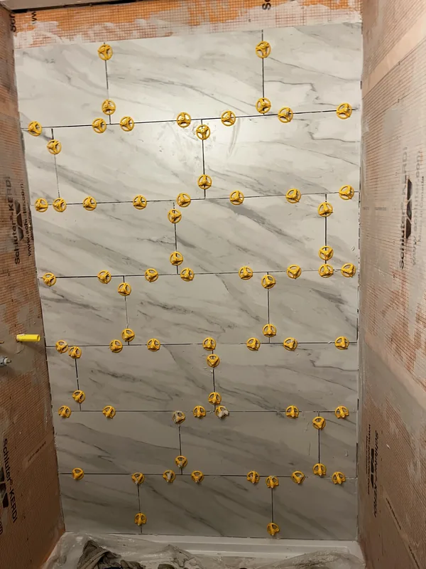 Close-up of tile with levelers for perfect alignment