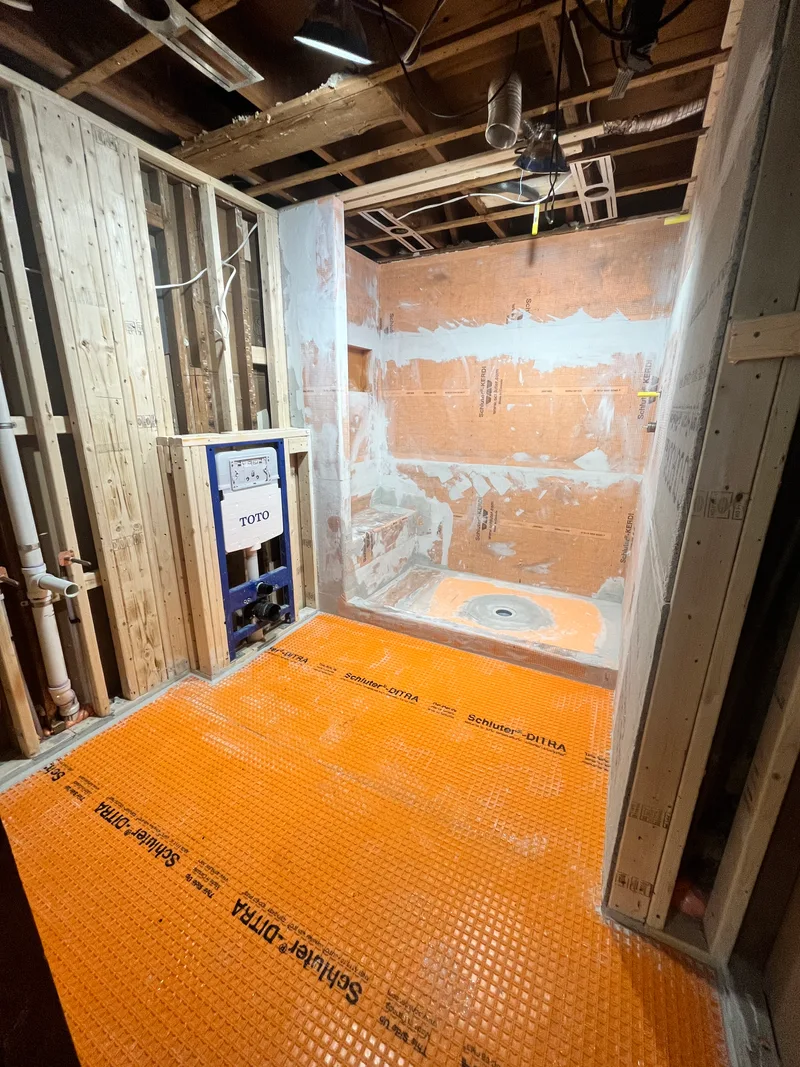Schluter Kerdi board shower walls and Ditra floor with a bonded-flange drain set in the pan