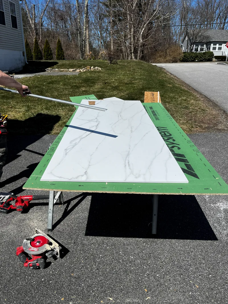 Composite panel laid on a bench outdoors and cut along a straightedge